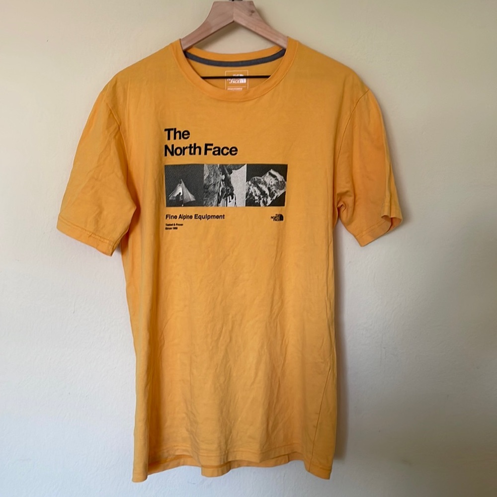 Yellow North Face T with climbing photos. Size medium